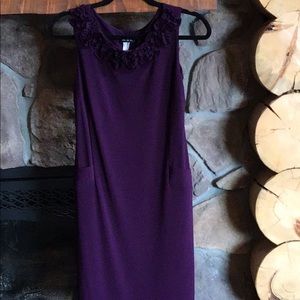Sleeveless, wine colored dress, very comfortable.